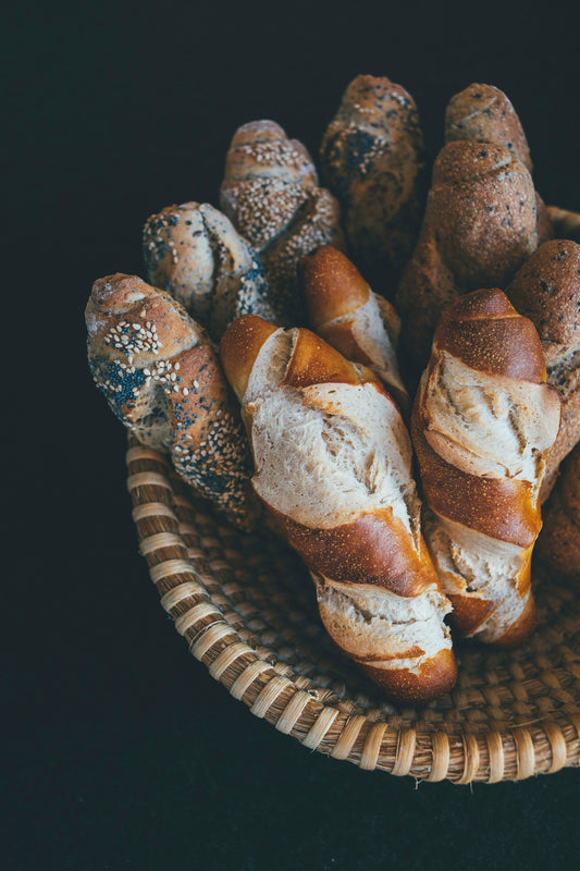 baked bread on brown wicker bowl