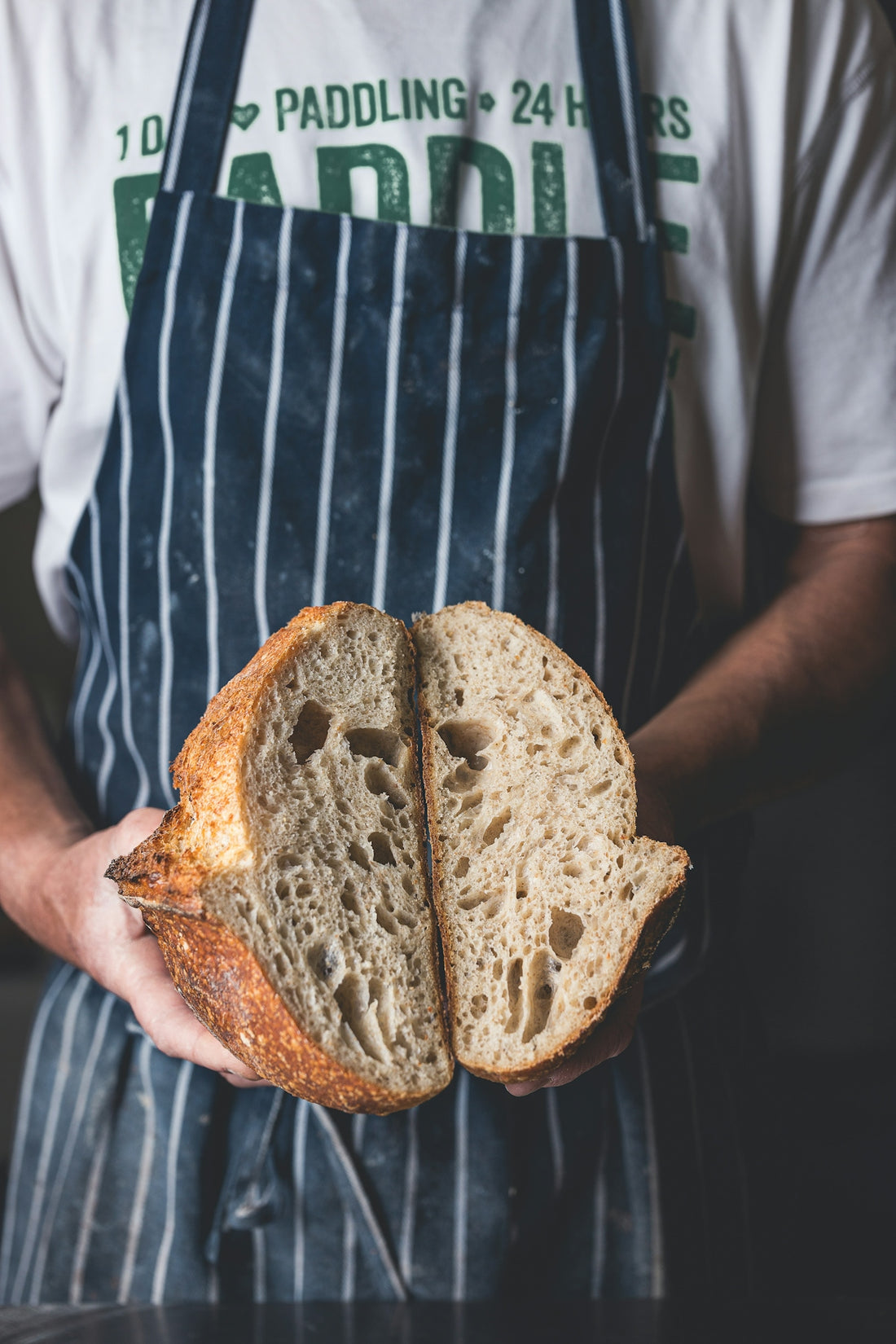 A man holding a loaf of bread in his hands