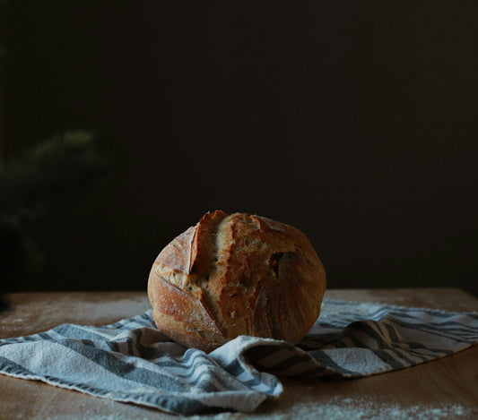 A loaf of bread sitting on top of a wooden table