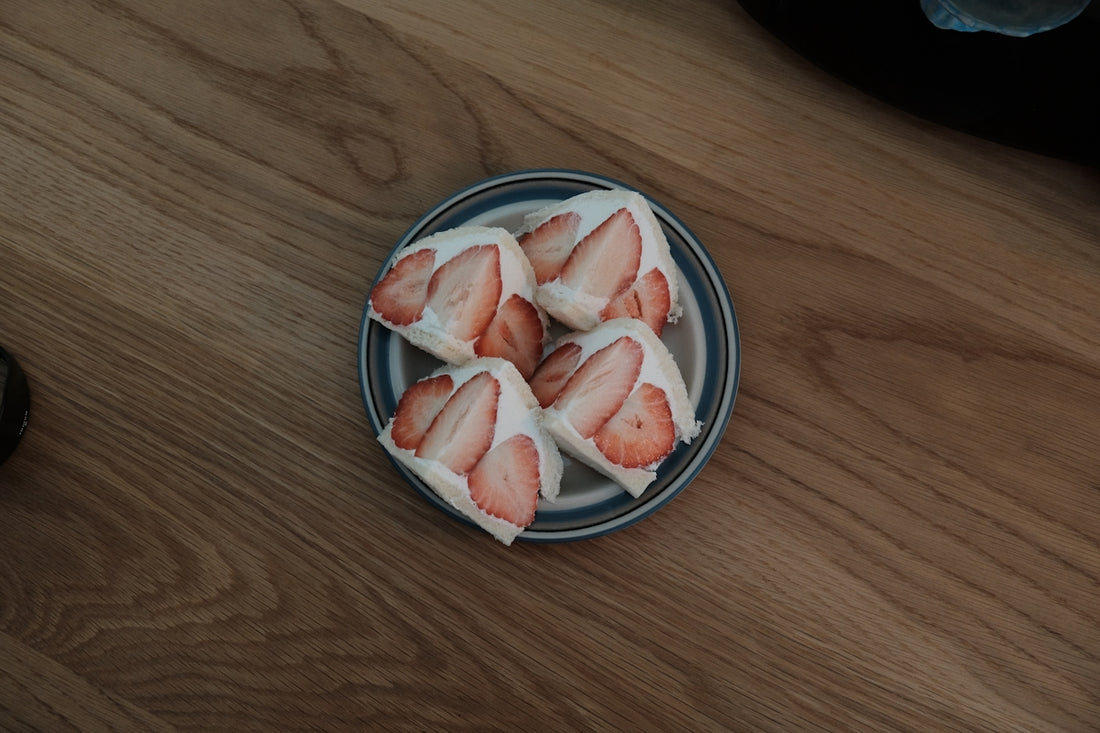 Strawberry treats on a blue-rimmed plate.