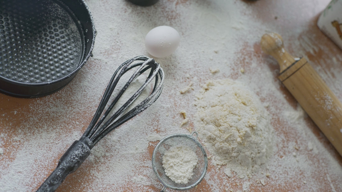Baking ingredients are prepared on a floured surface.